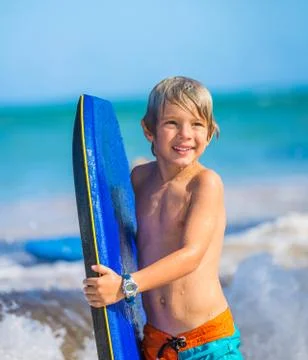 Happy young boy having fun at the beach on vacation, Stock Photos