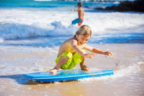 Happy young boy having fun at the beach on vacation, Stock Photos