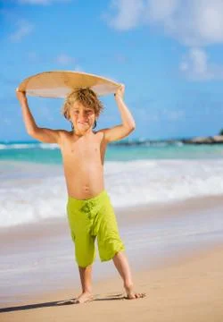 Happy young boy having fun at the beach on vacation Stock Photos