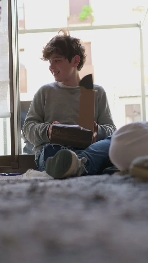 Happy young boy opening a gift box Stock Footage 322773644