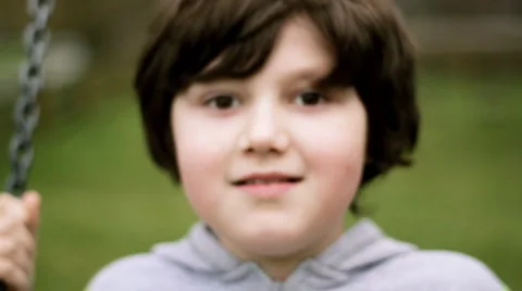 Happy young boy on a swing Stock Footage 942020
