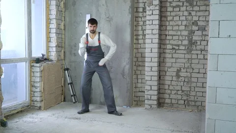 Happy young builder dancing and having fun at construction site Stock Footage 102889213