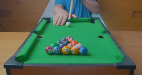 Happy young child playing table pool during the pandemic lockdown Stock Footage 144380045