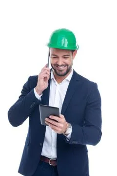 Happy young construction manager calling and using tablet isolated Stock Photos
