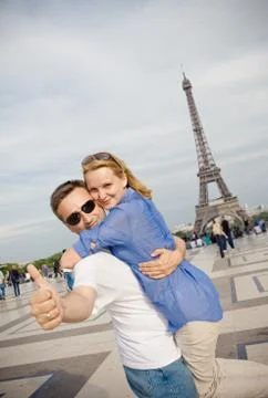 Happy young couple on the background of the Eiffel Tower in Paris. Honeymoon in Stock Photos