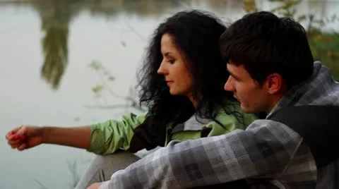 Happy young couple caught a fish at sunset Stock-Footage 10749545