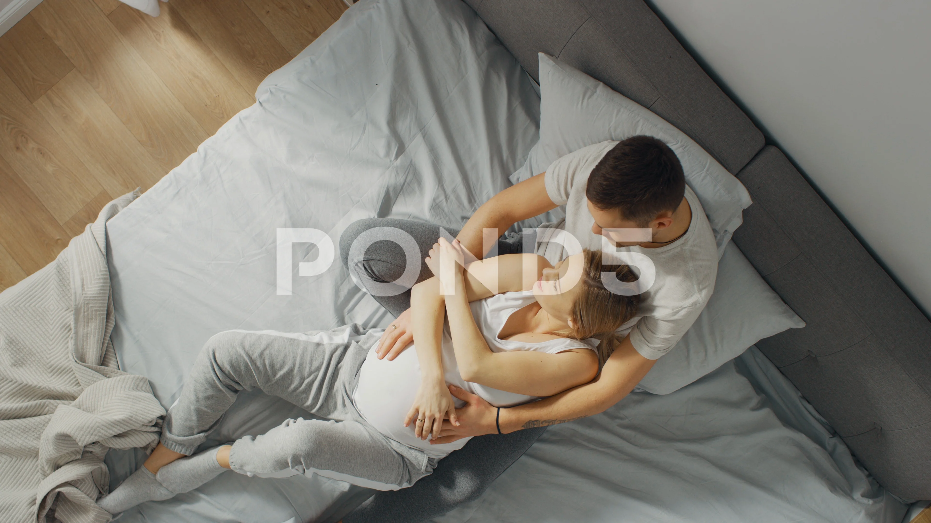 Happy young couple sleeping in bed and hugging, love and