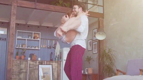 Happy young couple dancing in the kitchen in slow motion Stock Footage 88615008