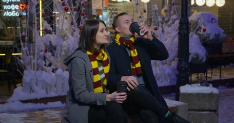 Happy young couple on a date during the Christmas holidays. Friends are sitting Stock Footage 220693541
