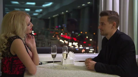 Happy young couple in evening cafe, having a great time together. Stock Footage 60055850