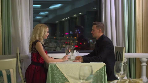 Happy young couple in evening cafe, having a great time together. Stock Footage 60056464