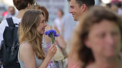 Happy Young Couple Flirting On A Date In The City. They are standing in the Stock Footage 65772481