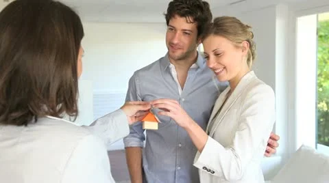 Happy young couple getting keys of their new home Stock Footage 14829559