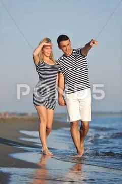 Happy young couple have romantic time on beach Stock Photos