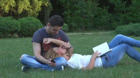 Happy young couple is having fun in the park 스톡 동영상 23930627