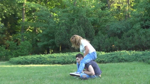 Happy young couple is having fun in the park 스톡 동영상 24690892