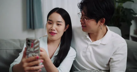 Happy young couple having fun video chatting with friend. 스톡 동영상 313972597