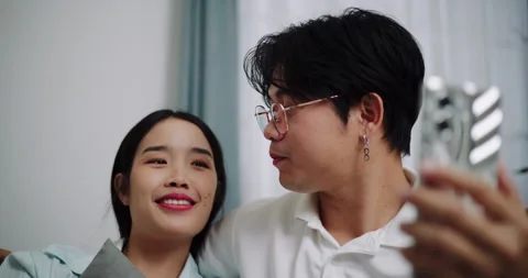 Happy young couple having fun video chatting with friend. Stock-Footage 313972766