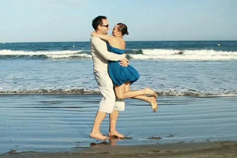 Happy young couple hugging each other at the beach, slow motion NTSC Stock Footage 10872659