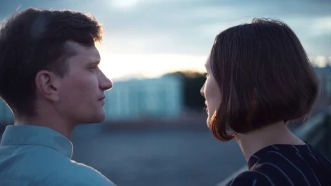 Happy young couple looking at beautiful sunset standing on the bridge Stock Footage 79357656