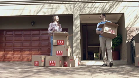 Happy young couple moving/ sorting their boxes while moving into a new house. Stock Footage 199631502
