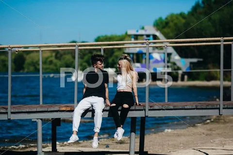 Happy young couple on the pier Stock Photos