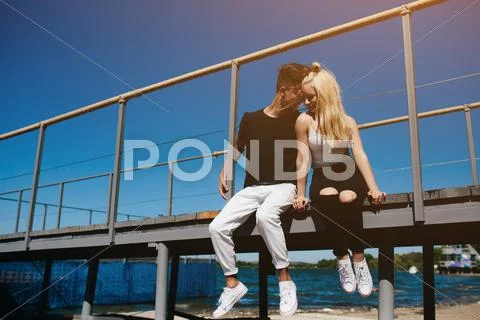 Happy young couple on the pier Stock Photos