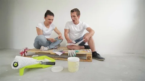 Happy Young Couple Planning Design Project for Their Apartment Sitting on Floor Stock Footage 80928225
