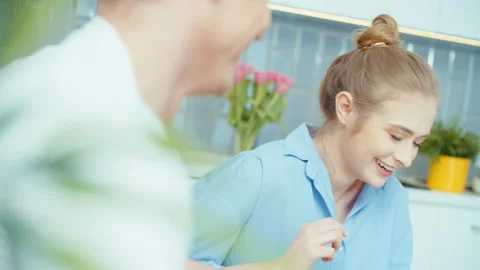 Happy young couple sitting in a kitchen and having fun. 動画素材 86717080