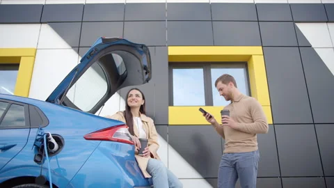 Happy young couple smiling and talking while drinking coffee Stock Footage 247453074
