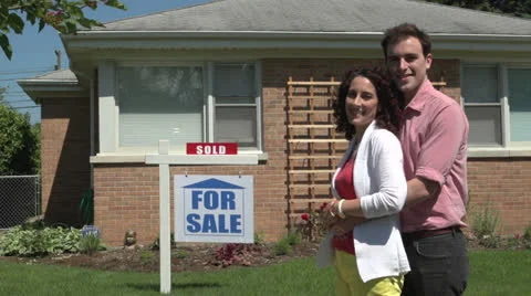 Happy young couple standing outside a sold house. Stock Footage 24756477