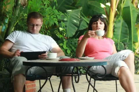 Happy young couple with tablet drinking coffee in bar, outdoors Stockbeeldmateriaal 10791992