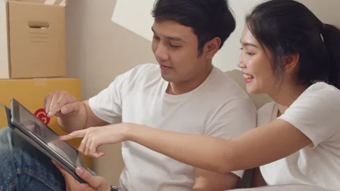 Happy young couple use digital tablet discuss interior design renovation ideas. Stock Footage 135642803