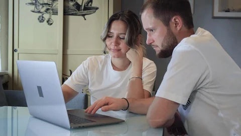 Happy young couple using laptop for ecommerce doing online shopping Stock Footage 128595951