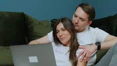 Happy young couple using laptop for ecommerce, doing online shopping together. Stock Footage 150819056