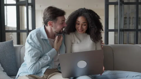 Happy Young Couple Using Laptop Relaxing Together at Home Stock Footage 295195174