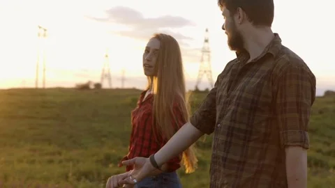 Happy Young Couple Walking On Road After Sunrise Or Sunset With Guitar Vídeos de archivo 76043802