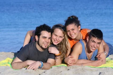 Happy young couples having fun at beach Stock Photos