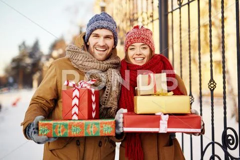 Happy young dates with wrapped xmas gifts Stock Photos