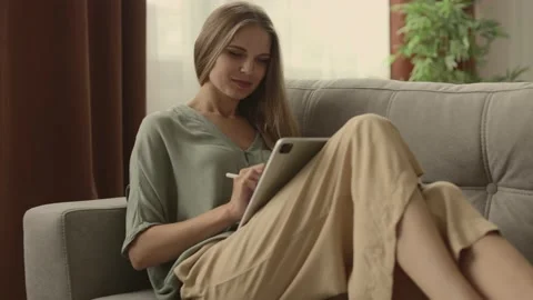 Happy young designer drawing on a graphics tablet with a stylus pen. Stock Footage 224536011