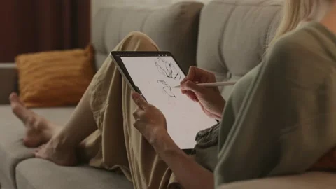 Happy young designer drawing on a graphics tablet with a stylus pen. Stock-Footage 224536373