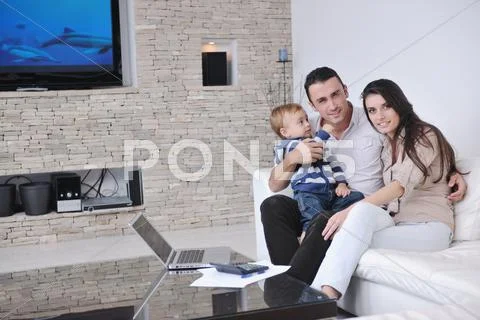 Happy young family have fun at home Stock Photos