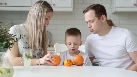Happy young family having Breakfast in the kitchen. Healthy food. Bright interio Stock Footage