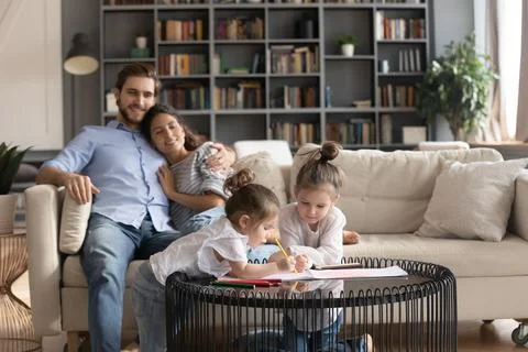 Happy young family with kids relax in living room Stock Photos