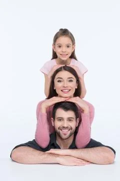 Happy young family with one child looking at camera on white Stock Photos