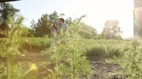 Happy young family with one year old child walking in the field at the sunset. Stock Footage 65515744