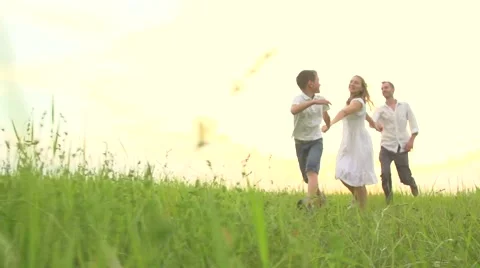 Happy Young Family running on summer field. Stock Footage 59088536