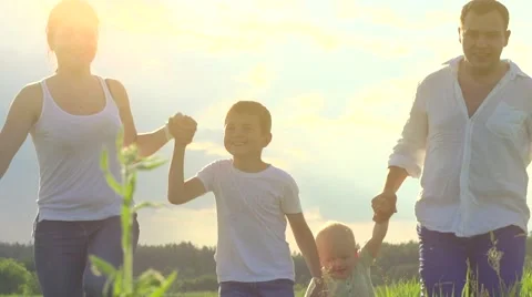 Happy young family with two children walking on summer field Video stock 59081261