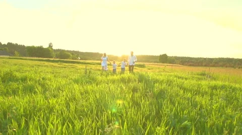 Happy Young Family with two children running on summer field Stock Footage 59088285
