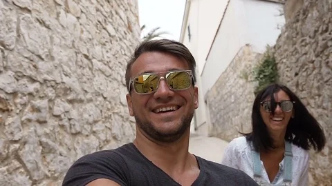The happy young family is walking in the historic European streets of the old Stock Footage
